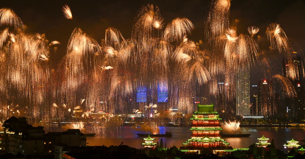 Fireworks illuminate a pagoda and city skyline in China