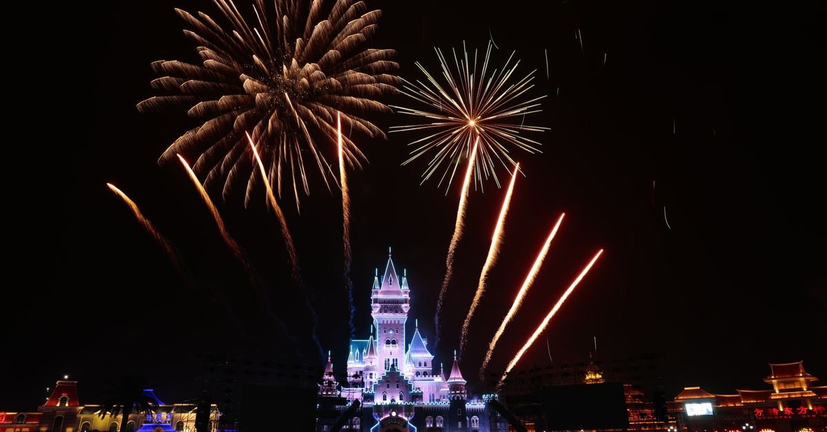 Fireworks display over an illuminated castle at a family resort in Orlando