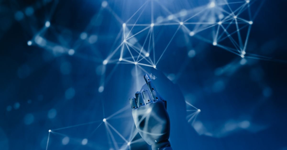 Robotic hand reaching into a digital network, symbolizing AI and data technology in regulatory compliance